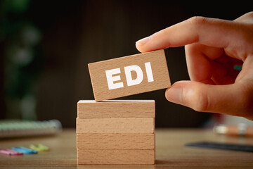 There is wood block with the word EDI. It is an abbreviation for Electronic Data Interchange as eye-catching image.