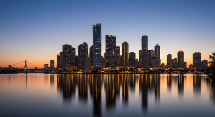 Fototapeta premium Skyscrapers Reflected in Water at Sunset