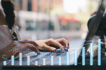 Woman sitting in cafe using tablet for analyzing data stock market in monitoring room with team pointing on the data presented in the chart, financial investment concept