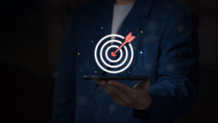 Business goal and strategy planning concept, a businessman showing a target with an arrow hitting the center to indicate success and efficiency