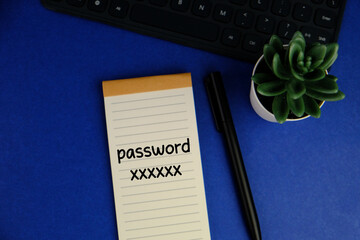 Sticky note with the word "password xxxx" on a laptop keyboard. Data protection, password strength concept.