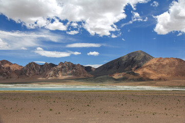Vast arid landscape with mountains and scattered water bodies