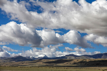 Vast mountain range under a sky filled with white clouds