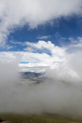 Clouds floating over a mountainous area with blue sky