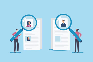 Two people examine resumes and profiles using large magnifying glasses for hiring and recruitment purposes