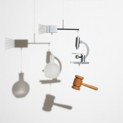  minimalist mobile sculpture hangs against a white background, featuring a paintbrush, a laboratory flask, a microscope, and a wooden gavel, casting distinct shadows - Generative AI