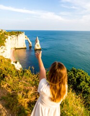 Girl points to sea arch