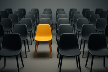 Naklejka premium Single yellow chair among rows of grey seats signaling standout leadership and innovation