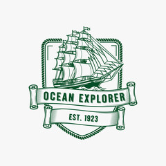 Vintage Ocean Explorer logo with sailing ship and rope border.