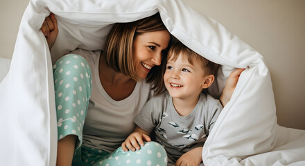 Cozy Moments Mother and Child Laughing Together Playing Peek a Boo Under a Blanket on Bed Home Comfort Fun Happy Family Bonding Childhood Motherhood Love Tenderness