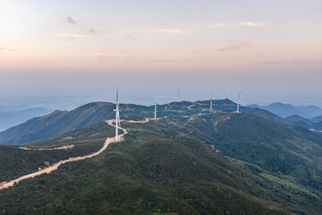 Wind power generation and windmills on a mountain at sunset.