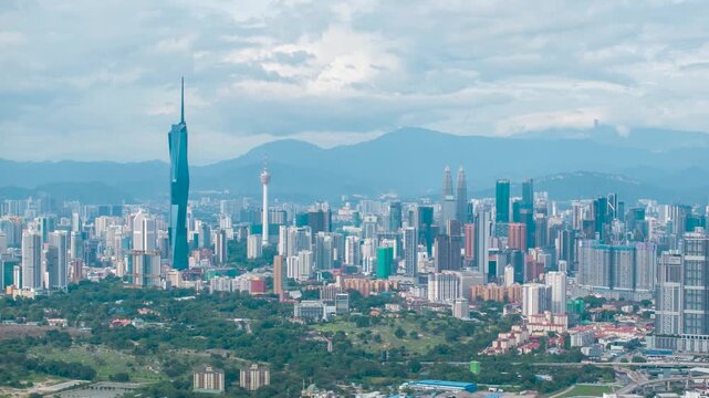 Aerial view time lapse 4k video of Kuala Lumpur city center view during dawn overlooking the city skyline in Federal Territory, Malaysia. Tilt up