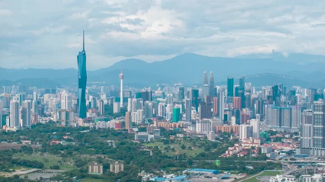 Aerial view time lapse 4k video of Kuala Lumpur city center view during dawn overlooking the city skyline in Federal Territory, Malaysia. Tilt down