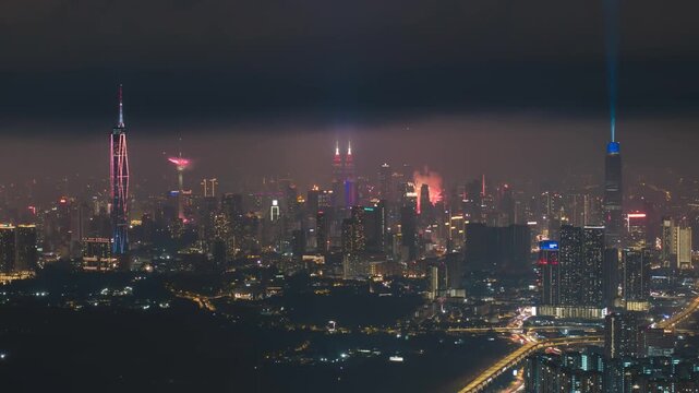 Aerial view of night scene at Kuala Lumpur with fireworks show. Tilt down