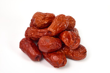 A pile of dried jujube fruits (Chinese red dates) on a white background.