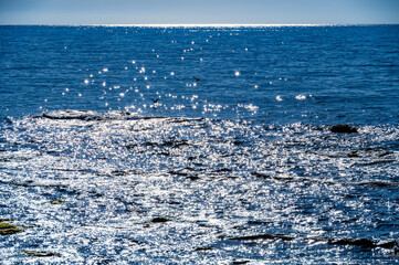 Backlit Ocean Surface with Sparkling Reflections Extending to the Horizon