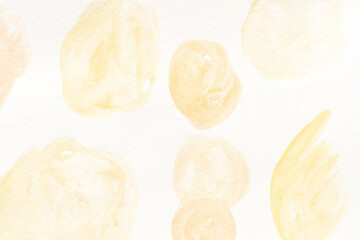 Soft pastel watercolor abstract background with yellow and peach brush strokes on paper texture.