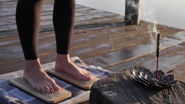close-up of a womans bare feet on a sadhu board