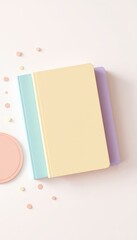 Pastel colored composition featuring stacked books, round shapes, and a clean background, ideal for a stationery product presentation