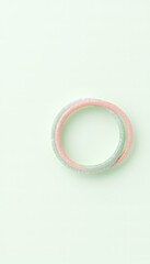 Two iridescent circular ornaments on a plain pastel background create a minimal and clean aesthetic