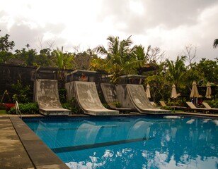 Outdoor pool with water slides and tropical landscaping