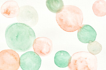 Soft watercolor circles in pastel greens and oranges on white background.