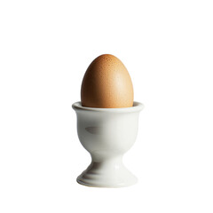 Single brown egg presented in an elegant white ceramic egg cup holder