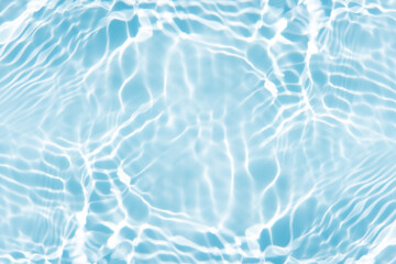 Blue water with ripples on the surface. Defocus blurred transparent blue colored clear calm water surface texture with splashes and bubbles. Water waves with shining pattern texture background.
