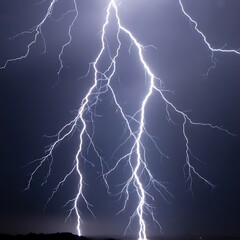 Powerful lightning strikes illuminate the night sky with bright energy and dramatic force of nature