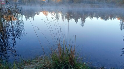 Morning fog over the river in the early autumn. Landscape.