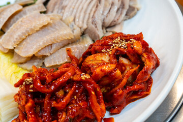 spicy radish kimchi with boiled pork and fermented skate in Samhap cuisine