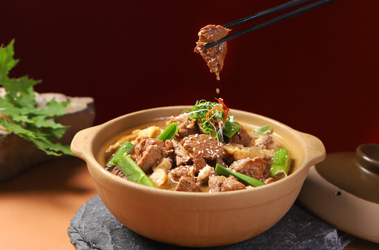 Traditional Chinese casserole beef dish, kitchen table background
