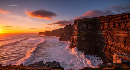 Dramatic Sunset Over Cliffs and Waves Crashing on the Shoreline