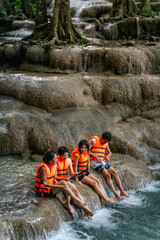 Young Asian man and woman travel nature forest hiking and camping on summer holiday vacation....