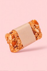 A healthy granola bar with nuts and oats, wrapped in paper, set against a soft background.