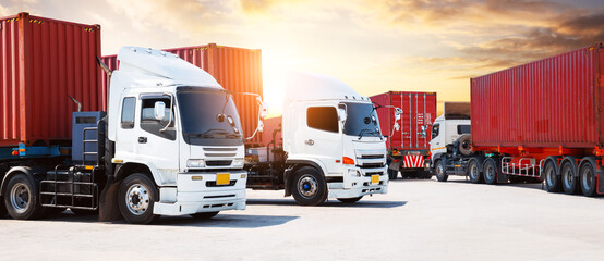 Semi Trailer Trucks on The Parking Lot at Sunset Sky. Big Rig. Tractor Truck. Shipping Cargo Container Trucks at The Port. Economy Business Transport on Road. Trucking. Freight Logistics Transport.