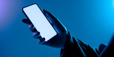 Individual presenting a smartphone displaying a blank screen against a dynamic, brightly colored backdrop in an artistic style.