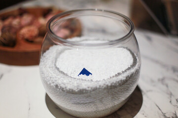 fish bowl with gift card and Styrofoam beads inside