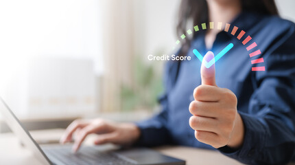Thumbs-up in front of a laptop with a colorful digital credit score gauge indicates solid financial...