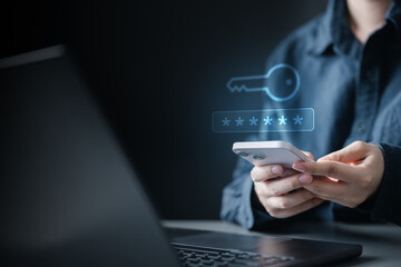 Person using smartphone with laptop, entering OTP code for two factor authentication, concept of...