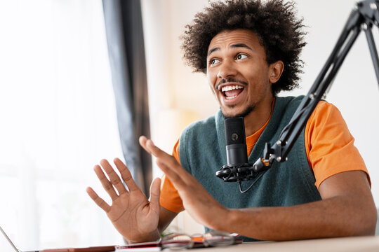 Young man recording podcast at home studio