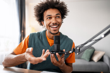 Young man recording podcast at home studio