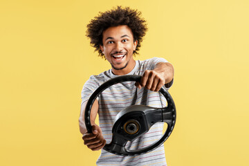 Happy young man driving steering wheel smiling