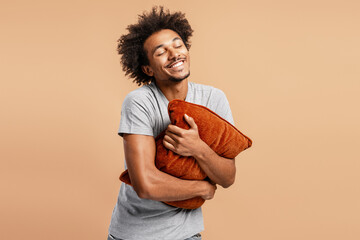 Happy man embracing comfort with soft pillow