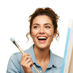 Smiling woman with paint on her face holding a paintbrush near canvas