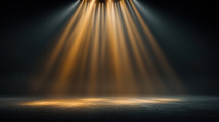 Obraz premium Blurred stage background with golden spotlight shining down, dramatic light beams cutting through haze, dreamy soft blur, dark minimal composition, wide blank copy space for text placement.