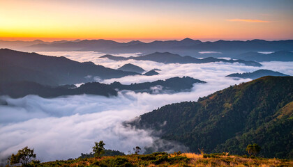 Obraz premium A misty mountain valley at dawn, with layers of soft clouds drifting