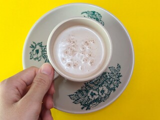 Malaysian Teh Tarik or Hot Milky Drink Served in a Traditional Cup. Mug of Frothy Hot Drink with Subtle Foam Texture