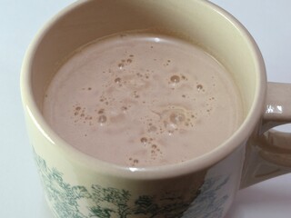 Malaysian Teh Tarik or Hot Milky Drink Served in a Traditional Cup. Mug of Frothy Hot Drink with...