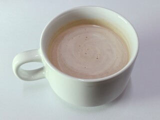 Malaysian Teh Tarik or Hot Milky Drink Served in a Traditional Cup. Mug of Frothy Hot Drink with Subtle Foam Texture
